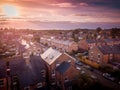 Sun setting with atmospheric effect over traditional British houses and tree lined streets.