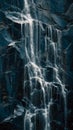 Dramatic Waterfall Cascading Down Dark Steep Textured Rock Face In Streaks Of Foamy Water Royalty Free Stock Photo