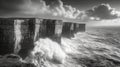 Dramatic Waves Crashing Against Rugged Cliffs in Black and White Royalty Free Stock Photo