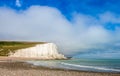 Dramatic white cliffs, blue sky and shingle beach at Cuckmere Haven