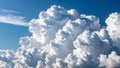 Dramatic white cumulus clouds against a bright blue sky, natural background. Royalty Free Stock Photo
