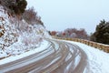 Dramatic winter landscape after snowfall. Picturesque winding road in mountains and trees covered with snow in the forest Royalty Free Stock Photo