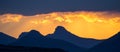 Dramatic yellow orange sunset over mountains with storm clouds, Lesotho, Southern Africa Royalty Free Stock Photo