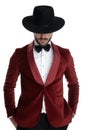 Dramatic young man in red velvet tuxedo holding hands in pockets Royalty Free Stock Photo