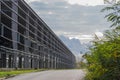 A street in the industrial district of the city. Steel skeleton of a large industrial hall once abandoned. Royalty Free Stock Photo