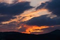 Dramatically cloudy sunset over wooded hills