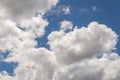 Dramatically illuminated fluffy clouds brightly back lit, blue sky. Royalty Free Stock Photo