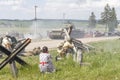 dramatization. soldier of great patriotic war holding a rifle. a lot of smoke. there are civilians