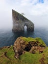 Drangarnir Rocks during mist and fog in the Faroe Islands, Denmark