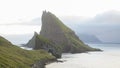 Drangarnir Sea Stack and TindhÃÂ³lmur Island near SÃÂ¸rvÃÂ¡gur village on the Faroe Islands in Denmark.