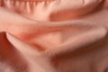 Draped apricot-colored simple cotton jersey fabric