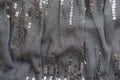 Draped black fabric with shiny paillettes