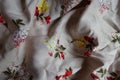 Draped beige cotton fabric with colorful floral print