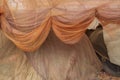 Draped orange colored fihsing nets Royalty Free Stock Photo