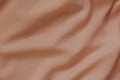 Draped peachy polyester fabric background