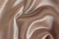 Draped peachy satin fabric background