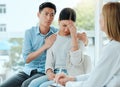 Drastic measures. a mature doctor comforting a young couple while delivering some bad news at work. Royalty Free Stock Photo