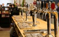 Draught beer taps on the counter of a pub