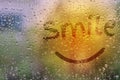 Draw text Smile on natural water drops glass window background Royalty Free Stock Photo