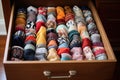 drawer filled with mismatched socks in various patterns