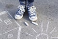 Women`s feet in sneakers are standing on the sidewalk Royalty Free Stock Photo