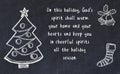 Drawing of christmas tree and handwritten greetings on black chalkboard