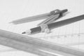 Drawing compass with black pensil and rulers on graph paper. Royalty Free Stock Photo