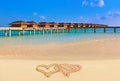 Drawing connected hearts on beach