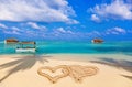 Drawing connected hearts on beach