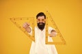 For drawing, draughting and design. Hipster holding drawing instruments on yellow background. Architect and engineer Royalty Free Stock Photo