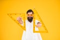 For drawing, draughting and design. Hipster holding drawing instruments on yellow background. Architect and engineer Royalty Free Stock Photo
