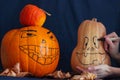 Drawing faces on pumpkins. prepare for happy Halloween Royalty Free Stock Photo