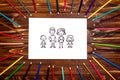 Drawing of a family with a pen on a white background in a frame of pencils Royalty Free Stock Photo