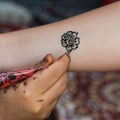 Drawing Floral Henna Tatoo on Female Arm Royalty Free Stock Photo