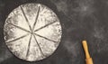 Drawing of flour in the form of a pizza and a rolling pin on a gray stone background. Free space for text . Top view Royalty Free Stock Photo