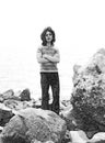 Black and white vintage portrait of a young hippie on the shore. Royalty Free Stock Photo