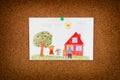 Drawing of a happy family and an apple tree and a house pinned on to cork board Royalty Free Stock Photo