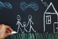 Drawing happy homosexual parents with child on a chalk board. Gay family concept