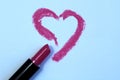 Drawing heart with lipstick on white paper, top view Royalty Free Stock Photo