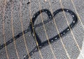 drawing of a heart on water drops on the rear window of the car. Royalty Free Stock Photo