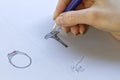 Drawing Jewelry Design. Artist designer drawing sketch jewelry on paper .