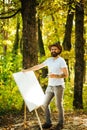 Drawing from life. Painter artist forest. Art concept. Painting in nature. Start new picture. Painter with easel and Royalty Free Stock Photo