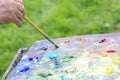 Drawing with oil paints on the nature. Palette Royalty Free Stock Photo