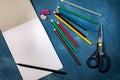 Drawing pad and colored pencils on blue background Royalty Free Stock Photo