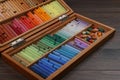 Drawing pastel set in box on wooden table, closeup Royalty Free Stock Photo