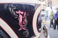 Drawing of Pink Panther in fileteado porteÃÂ±o style on a Mercedes Benz 911 bus
