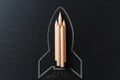 Drawing of a rocket on a black metal background with pencils. Startup concept Royalty Free Stock Photo