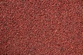 Drawing of rubber covering of sports grounds and paths. Thin rubber shavings of burgundy color. Texture of the coating for the Royalty Free Stock Photo