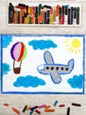 Drawing: Small blue airplane and hot air balloon