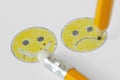 Drawing of smiley face with negative and positive expression with pencil and rubber - Negative emotion concept Royalty Free Stock Photo